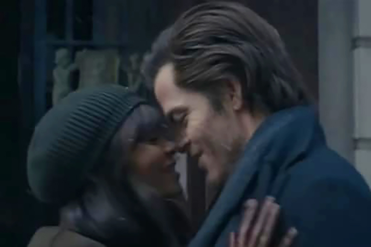 film still of actors embracing