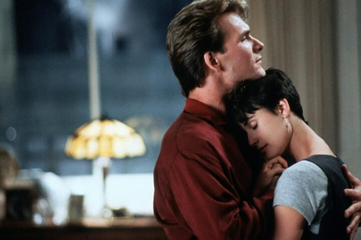 film still of actors in intimate embrace