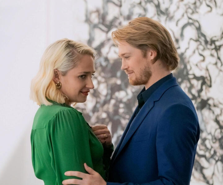 a couple embrace in front of a marble wall